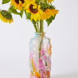 Kip & Co Swirl Sorbet tall vase with vibrant, swirling orange and pink patterns, standing upright on a white surface.