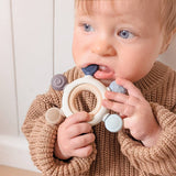 Living Textiles multi-surface teething wheel in steel blue with textured surfaces for soothing baby's gums.