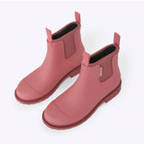 Merry People Bobbi gumboots in clay, waterproof rubber rain boots with a high-angle view and textured sole.