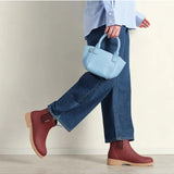 Merry People Bobbi Gumboots in brick red worn by a model, showcasing stylish waterproof footwear for rainy weather