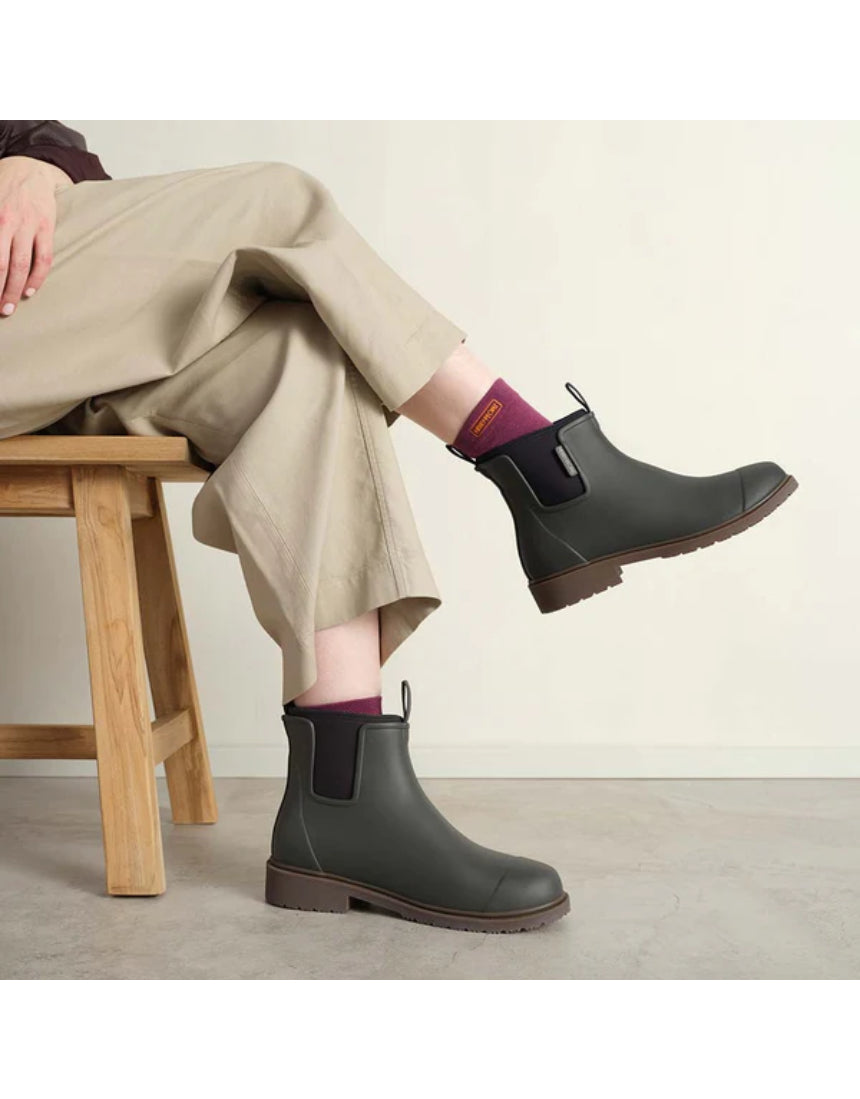 Merry People Bobbi gumboots in charcoal color worn by a model, showcasing waterproof rubber footwear for rainy weather.