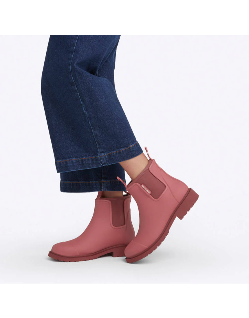 Merry People Bobbi Gumboots in clay color, stylish waterproof rubber boots for rainy weather, shown walking outdoors.