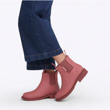 Merry People Bobbi Gumboots in clay color, stylish waterproof rubber boots for rainy weather, shown walking outdoors.