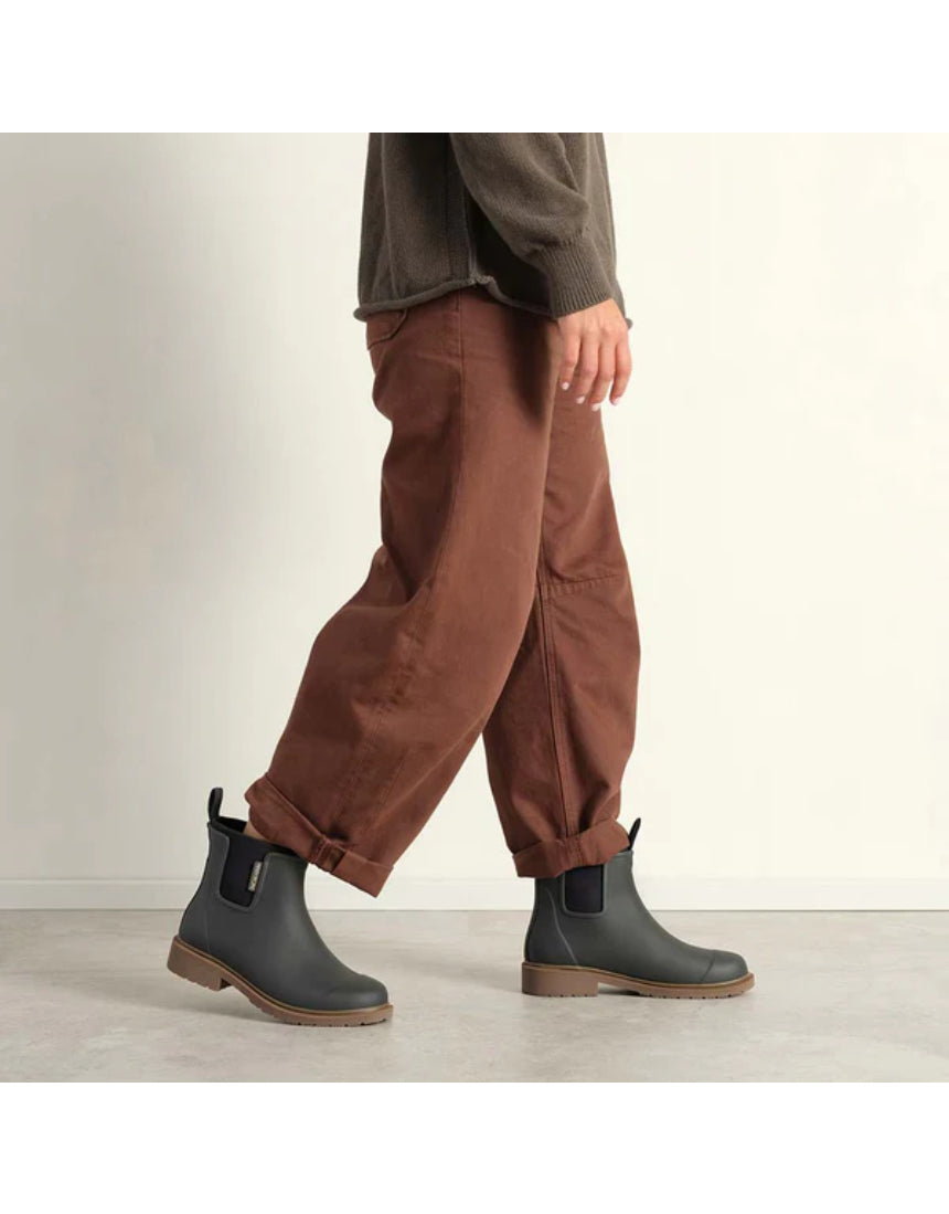 Merry People Bobbi Gumboots in charcoal color worn by a model, showcasing stylish waterproof footwear for rainy days.