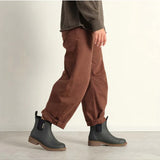 Merry People Bobbi Gumboots in charcoal color worn by a model, showcasing stylish waterproof footwear for rainy days.
