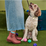 Merry People Bobbi Gumboots in clay color, stylish waterproof rubber boots on a person standing outdoors.
