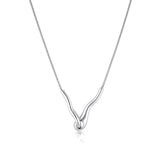 Linda Tahija Ripple Necklace featuring a sleek, modern silver design with smooth, flowing curves on a delicate chain.