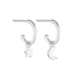 Linda Tahija star and moon charm earrings featuring delicate silver earrings with celestial-themed charms.