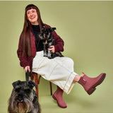 Merry People Bobbi Gumboots in clay color, stylish waterproof rubber boots for rainy weather, shown outdoors with greenery.