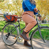 Merry People Bobbi gumboots in mocha color, stylish waterproof rubber boots, shown in a lifestyle outdoor setting.