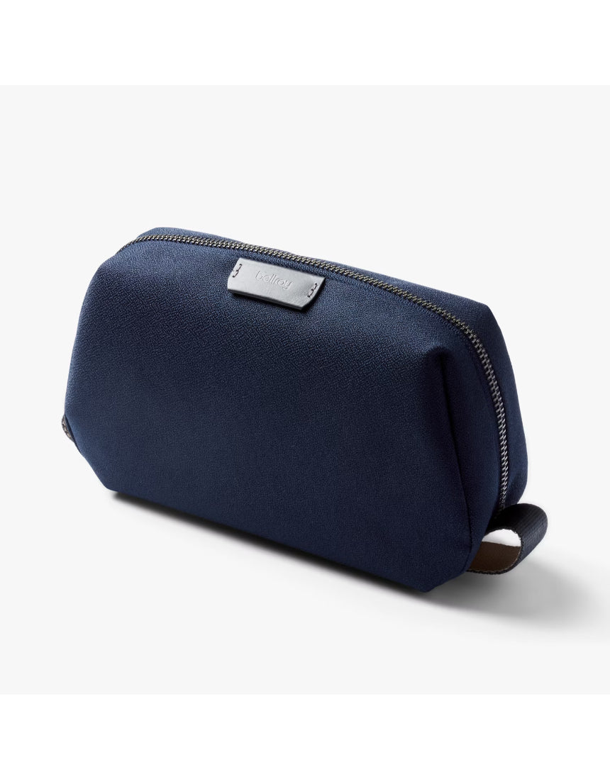 Bellroy Toiletry Kit in navy with zipper closure and multiple compartments for organizing personal grooming essentials.