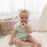 Living Textiles multi-surface teething wheel in rose color, featuring textured surfaces for soothing and chewing comfort for babies.