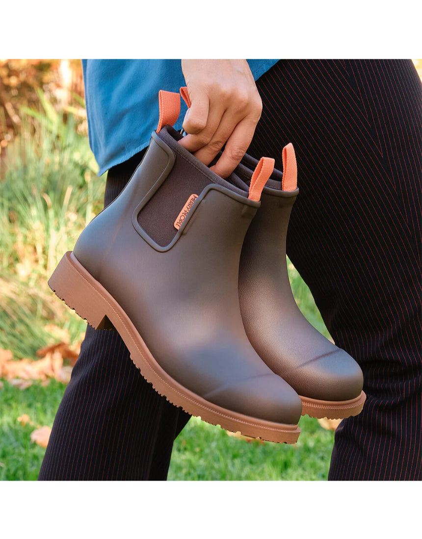 Merry People Bobbi Mocha gumboots shown outdoors, featuring waterproof design and stylish mocha color for rainy weather.