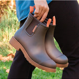 Merry People Bobbi Mocha gumboots shown outdoors, featuring waterproof design and stylish mocha color for rainy weather.