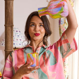Kip & Co Festiva glass and carafe set with colorful, floral design on clear glass for elegant beverage presentation.