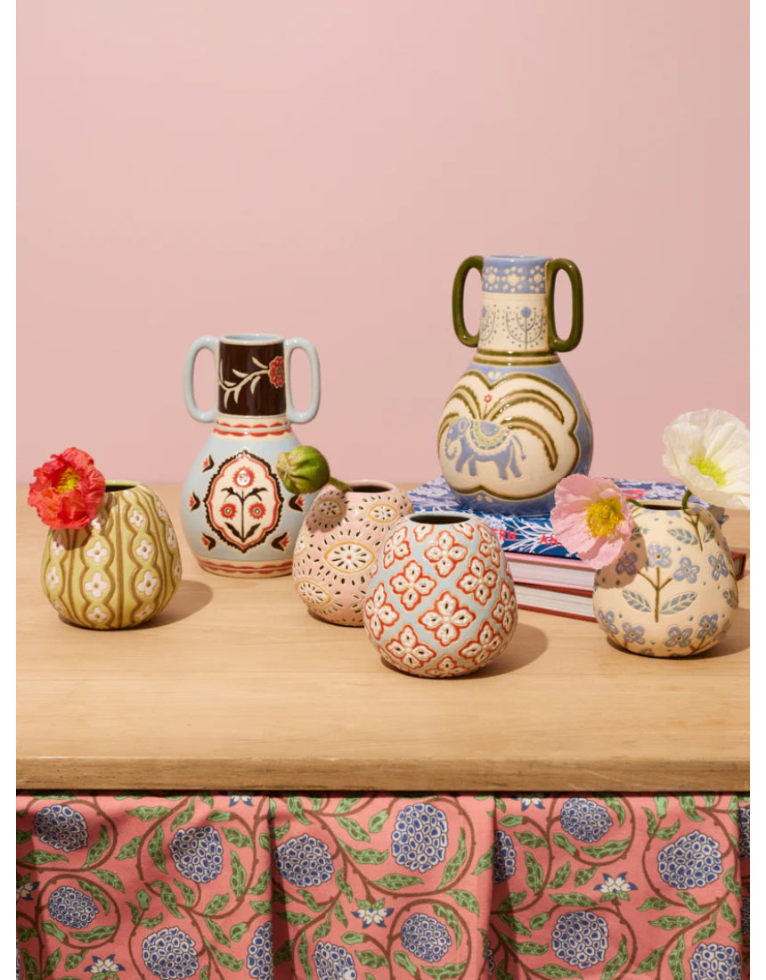 Jones & Co Samira Vase filled with colorful flowers, showcasing a stylish decorative vase on a neutral background.