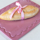 Pink Maison Apprêt Petite Chopping Board with smooth surface and compact design, ideal for kitchen prep and serving.