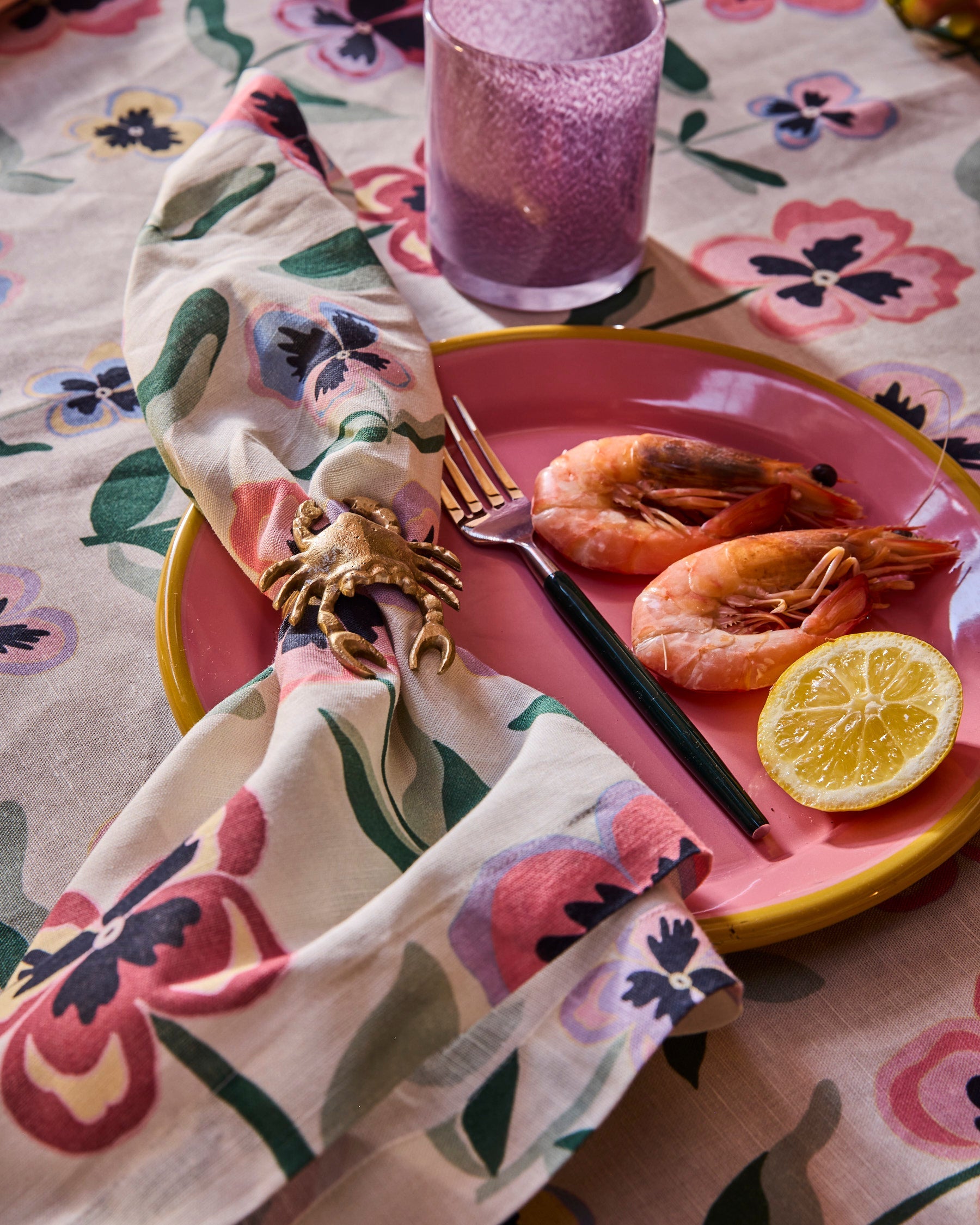 Kip & Co Pretty Pansy tablecloth featuring vibrant floral patterns on fabric for a stylish dining table.