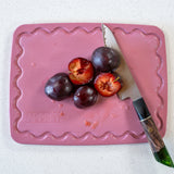 Maison Apprêt pink petite chopping board with smooth surface and compact size, ideal for food prep and serving.