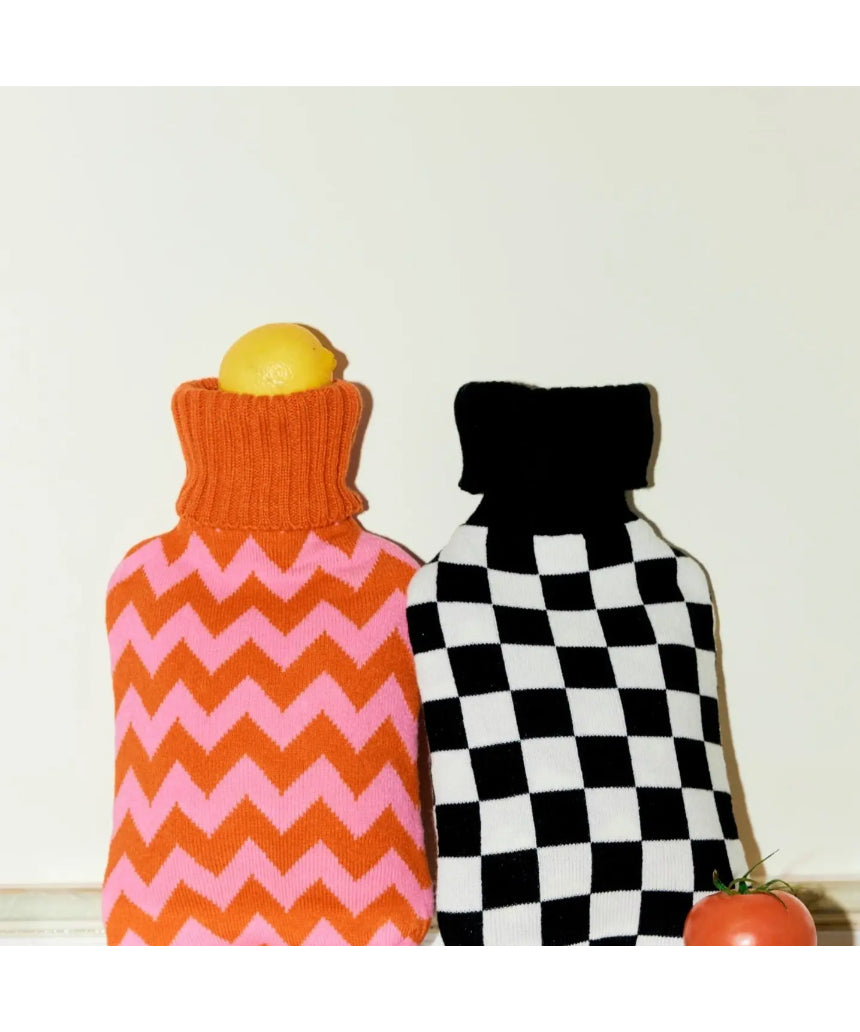 Casa Rolio hot water bottle with orange tangerine cover, soft fabric and flexible design for warmth and comfort.