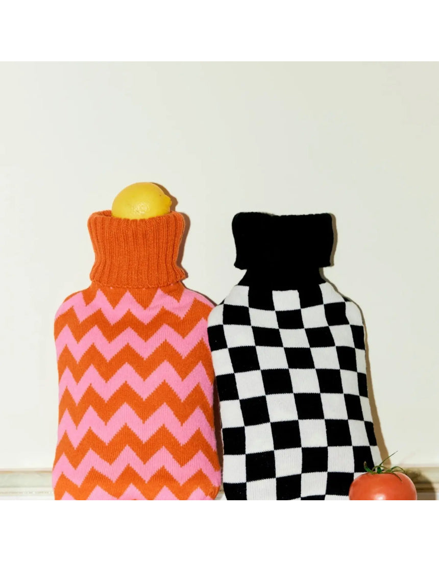 Casa Rolio hot water bottle with orange tangerine cover, soft fabric and flexible design for warmth and comfort.
