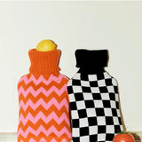 Casa Rolio hot water bottle with orange tangerine cover, soft fabric and flexible design for warmth and comfort.