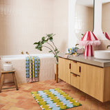 Kip & Co Genie bath mat with colorful, plush design featuring vibrant patterns, soft texture, and non-slip backing.