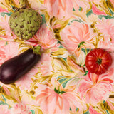 Kip & Co warm floral Breeze tablecloth with vibrant floral pattern, draped over a dining table for a cozy, colorful look.
