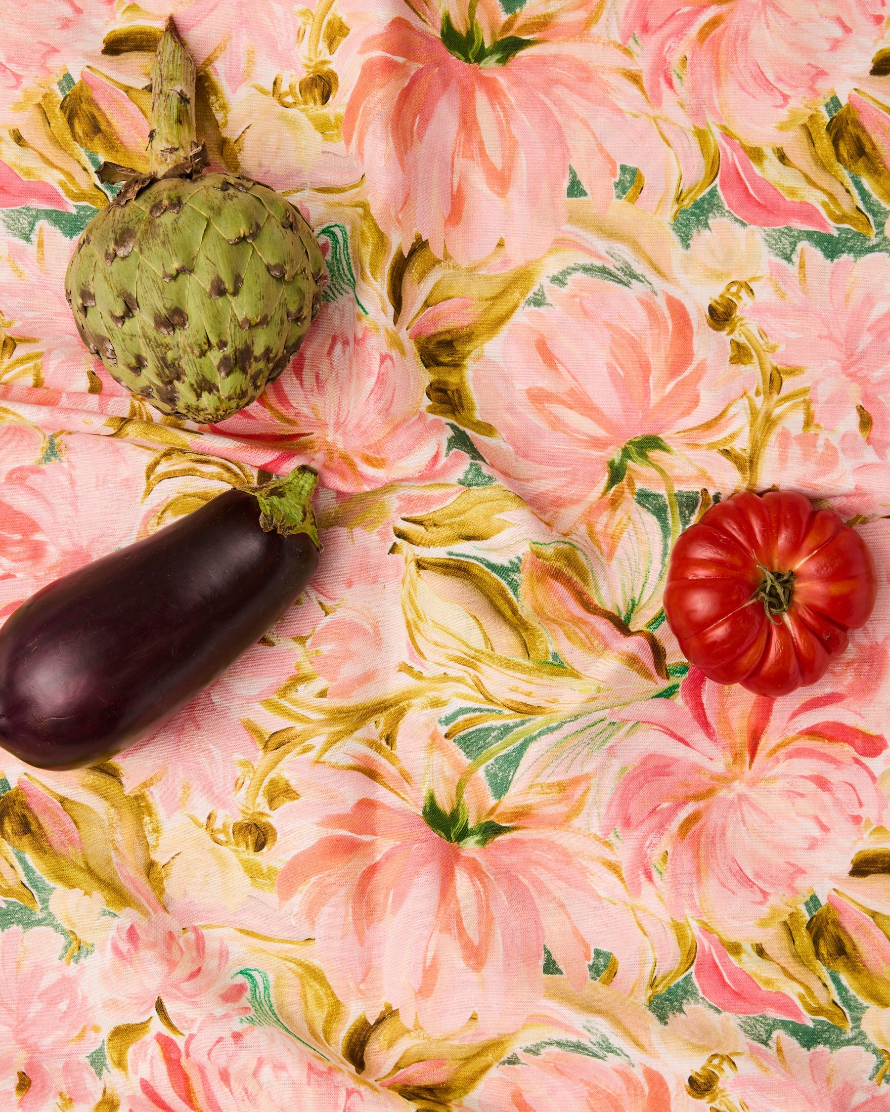 Kip & Co warm floral Breeze tablecloth with vibrant floral pattern, draped over a dining table for a cozy, colorful look.