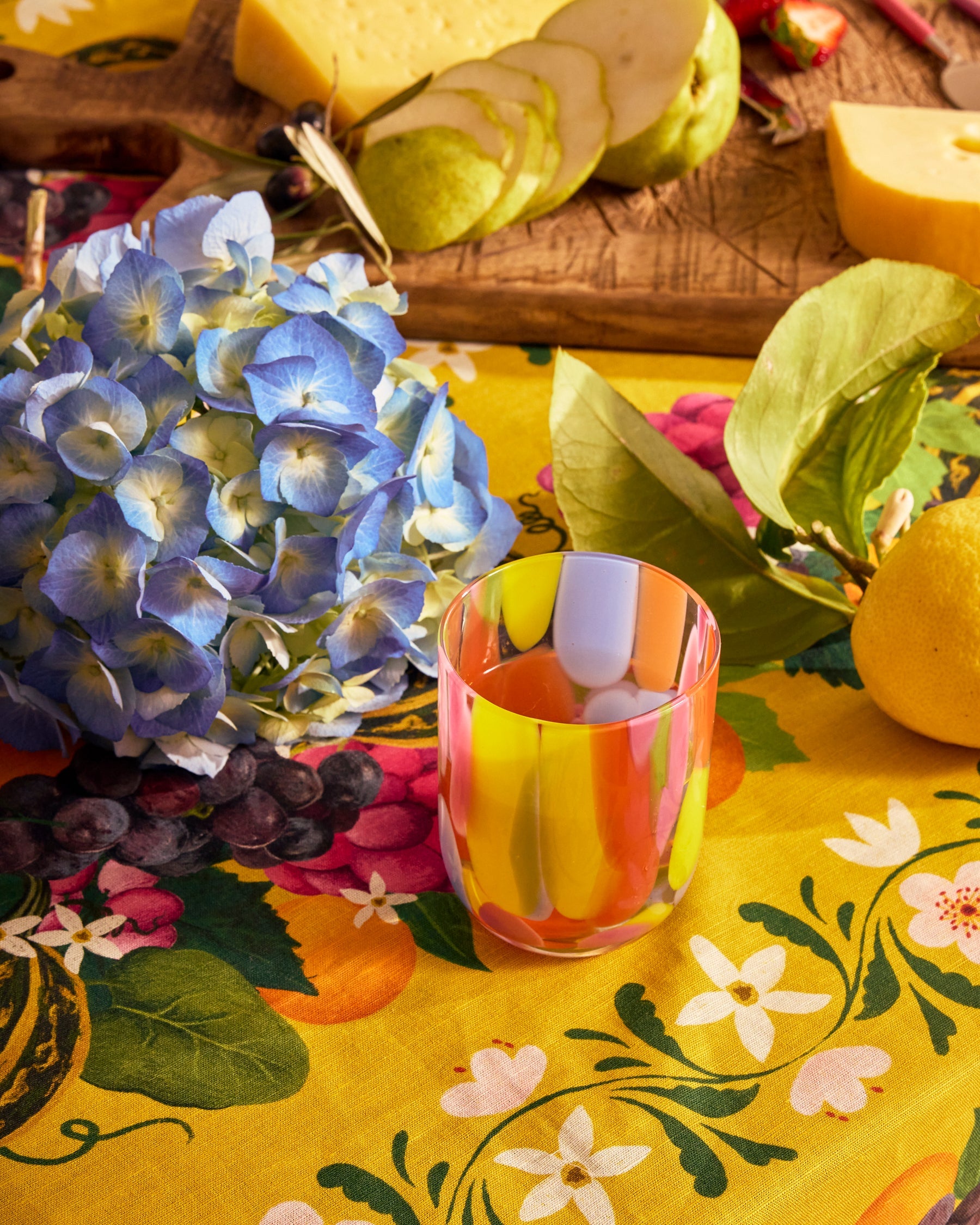 Kip & Co Festiva glass and carafe set with vibrant, colorful patterns, perfect for serving beverages in style.