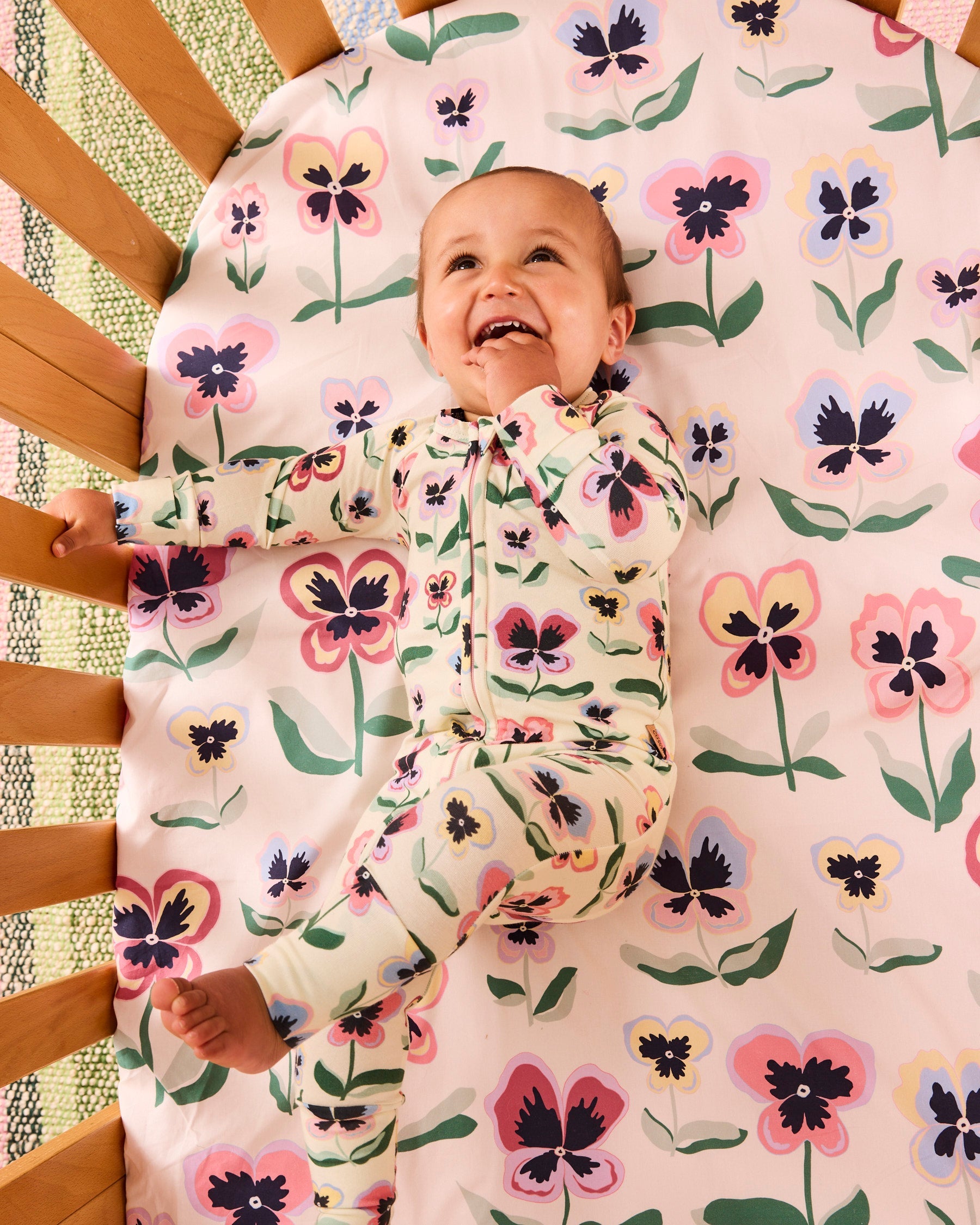 Kip & Co Pretty Pansy organic long sleeve zip romper for babies, featuring floral pattern and soft fabric.