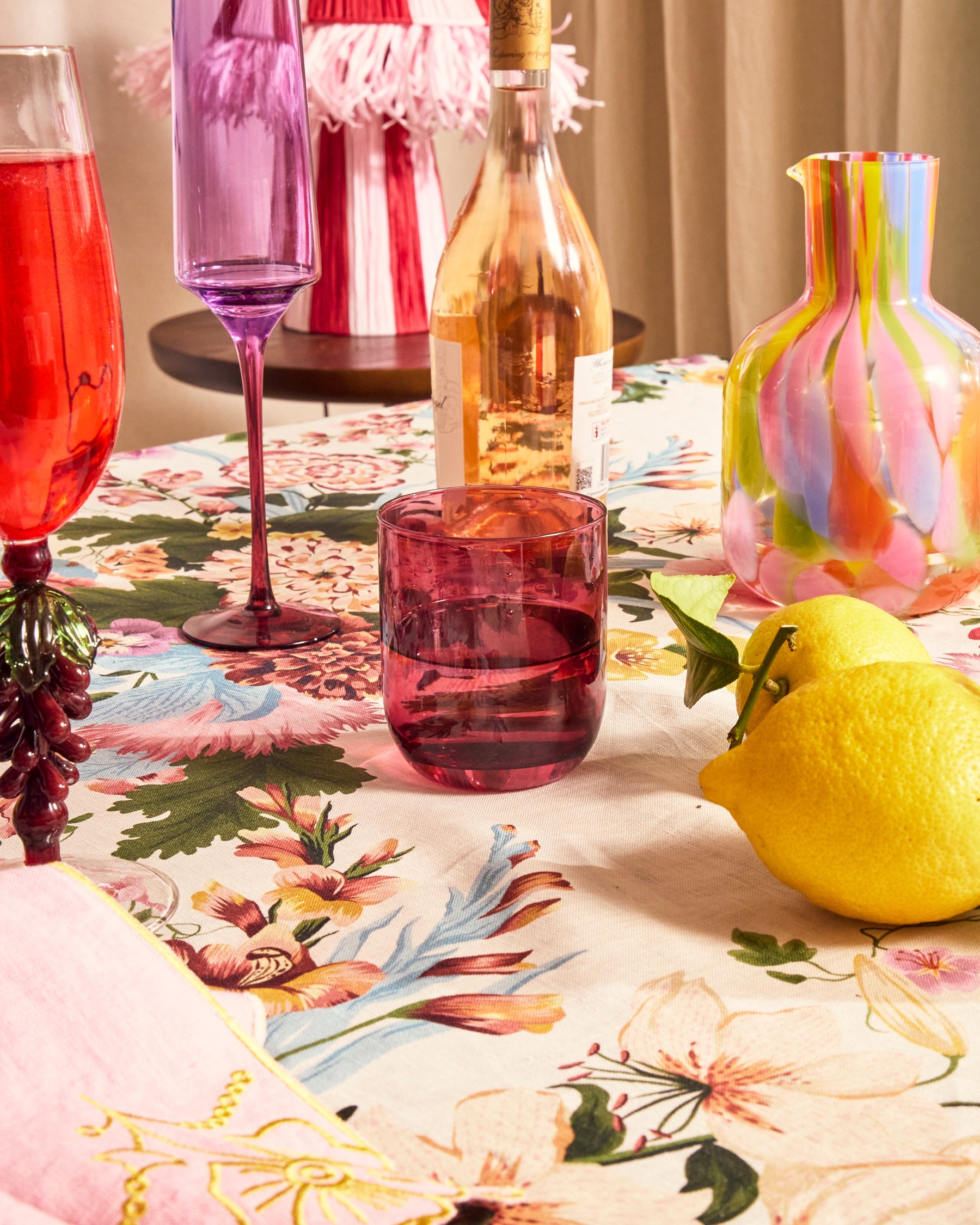 Kip & Co lilac fiesta glass and carafe set with colorful patterns, designed for serving beverages in a stylish, vibrant way.