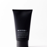 Hunter Lab Cleansing Facial Scrub in 150g container, a natural bath and body exfoliant with a textured scrub surface.