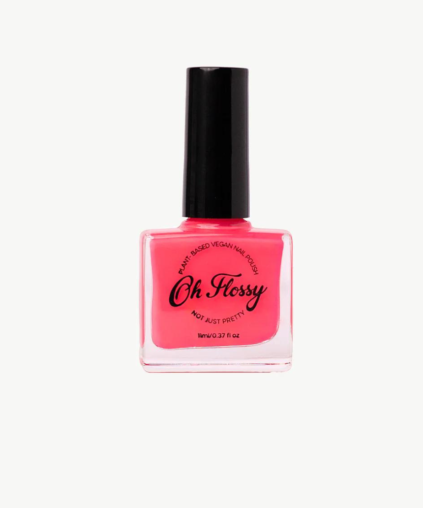 Kids nail polish by Oh Flossy in vibrant pink color, displayed in a clear bottle with a white cap.