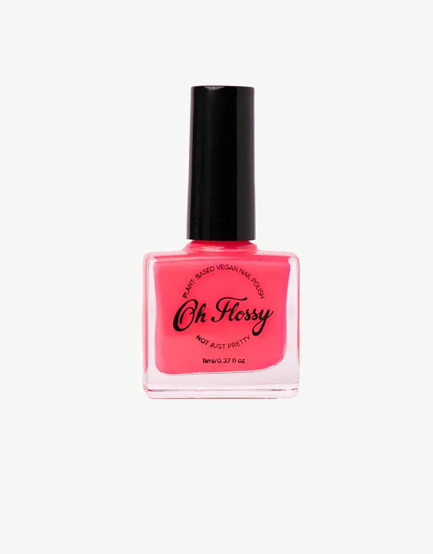Kids nail polish by Oh Flossy in vibrant pink color, displayed in a clear bottle with a white cap.