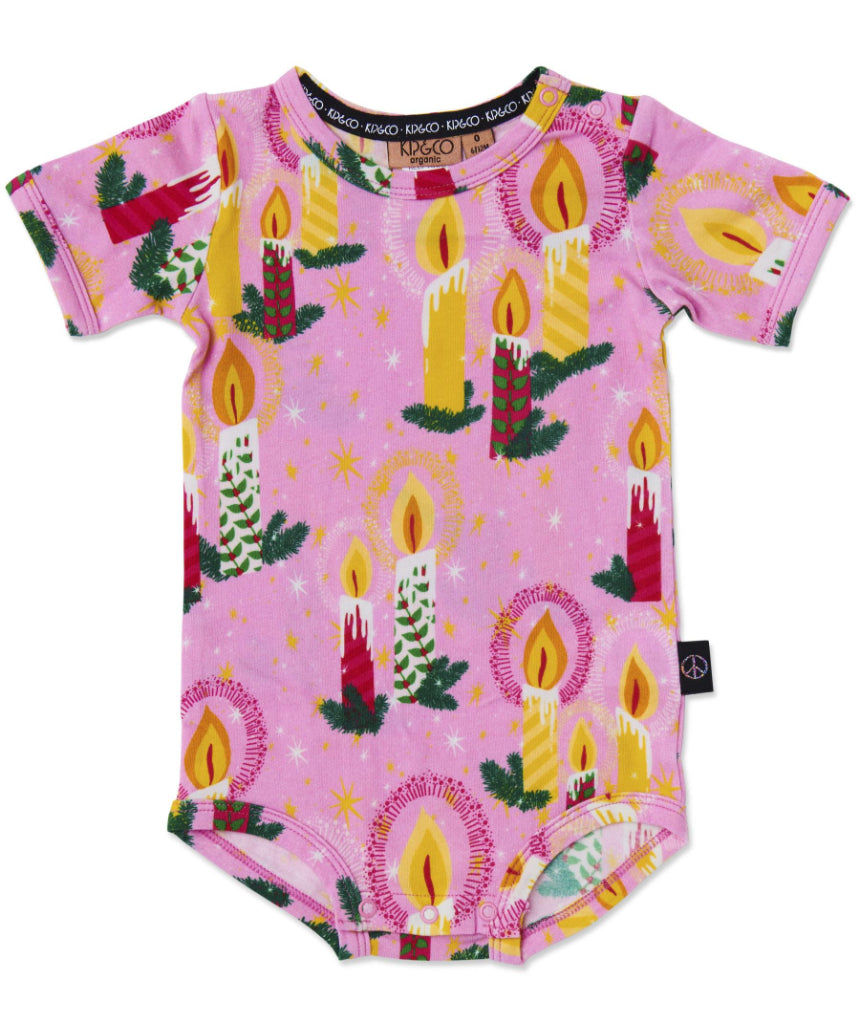 Kip & Co baby short sleeve romper in soft fabric with a colorful candlelight pattern, perfect for toddler comfort and style.