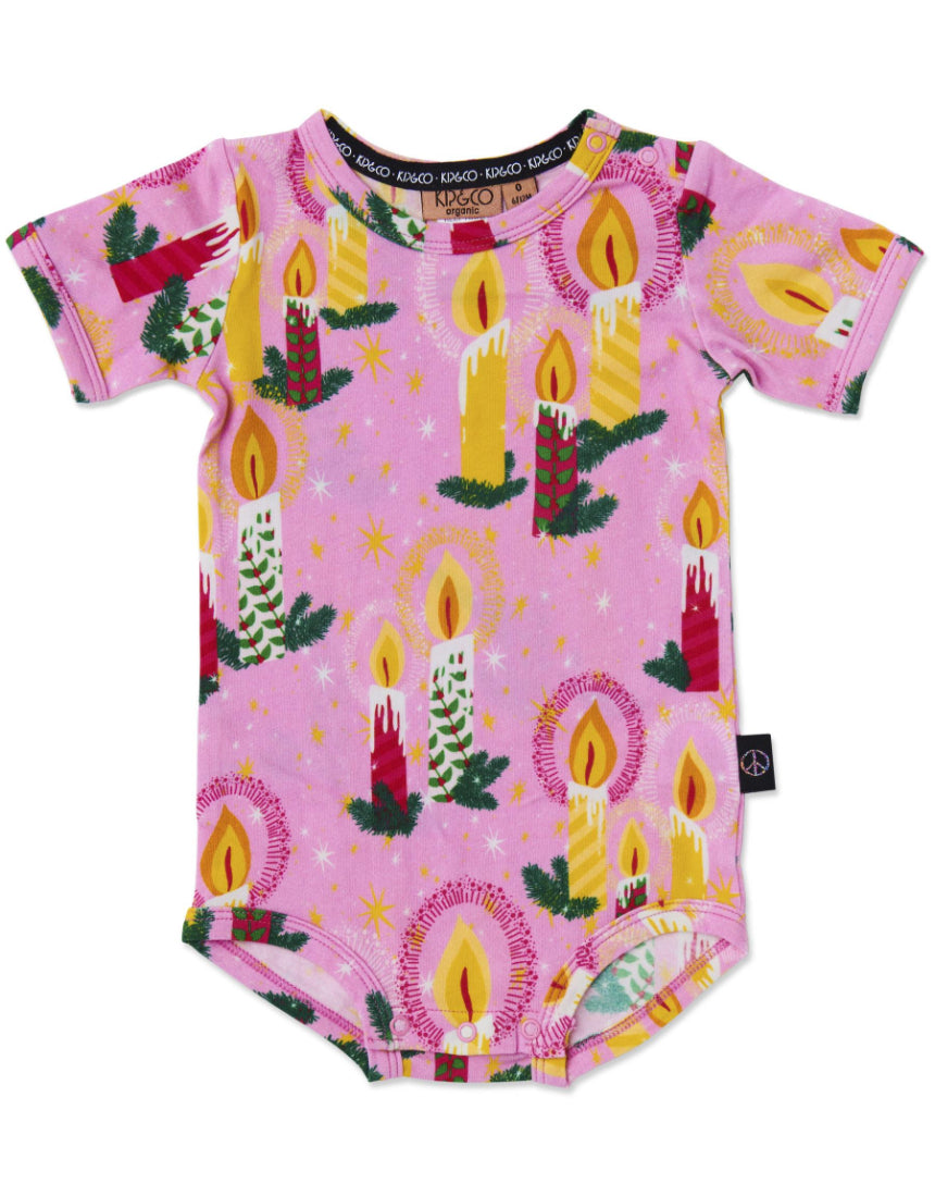 Kip & Co baby short sleeve romper in soft fabric with a colorful candlelight pattern, perfect for toddler comfort and style.