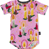 Kip & Co baby short sleeve romper in soft fabric with a colorful candlelight pattern, perfect for toddler comfort and style.