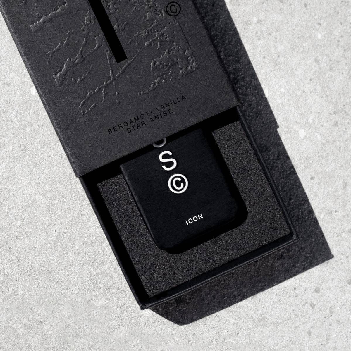 Icon Solid Cologne by Solid State, a sleek black bottle with a minimalist label, designed for portable, everyday fragrance application.