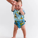 Kip & Co Reef Life cotton baby bib with colorful reef print, soft fabric, and adjustable neck closure for comfortable feeding.