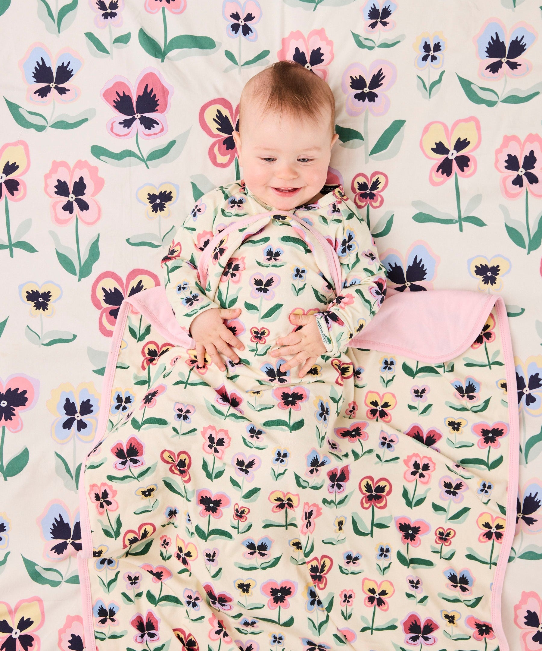 Kip & Co Pretty Pansy organic cotton baby blanket with floral pattern, soft and cozy for infants.