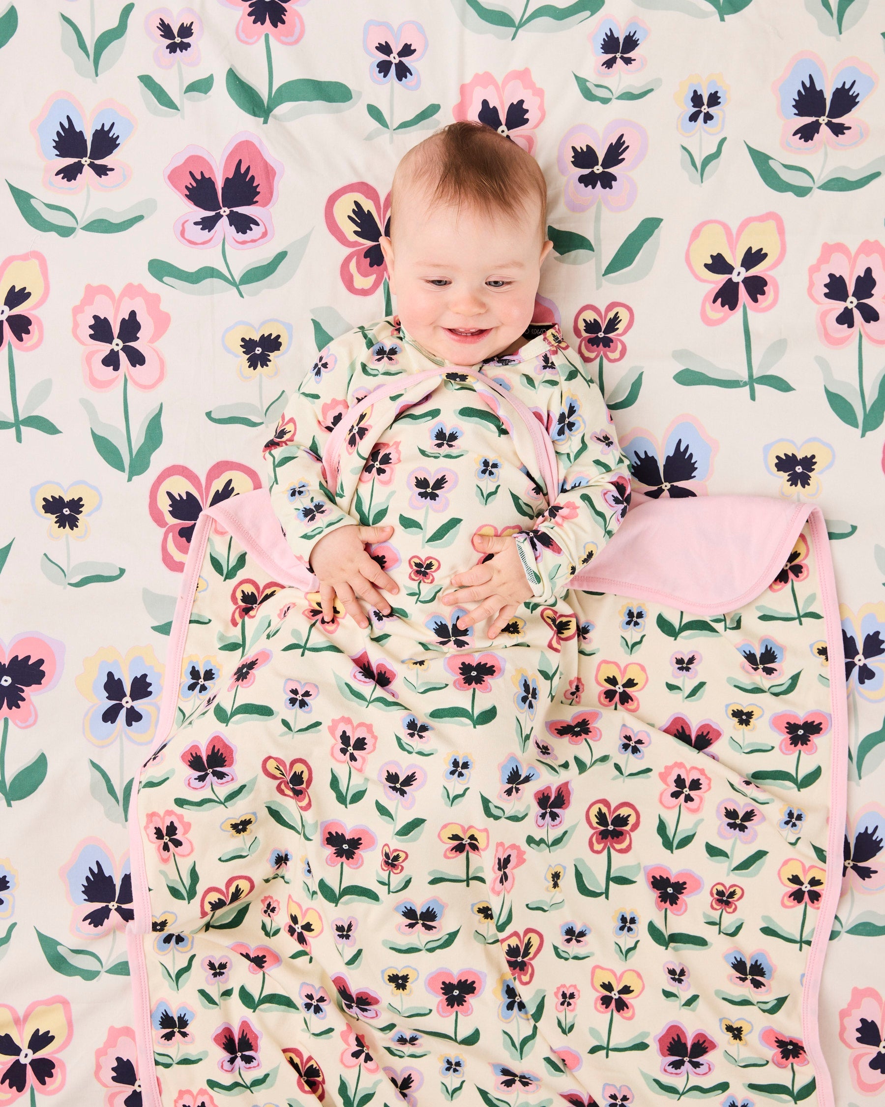 Kip & Co Pretty Pansy organic cotton baby blanket with floral pattern, soft and cozy for infants.