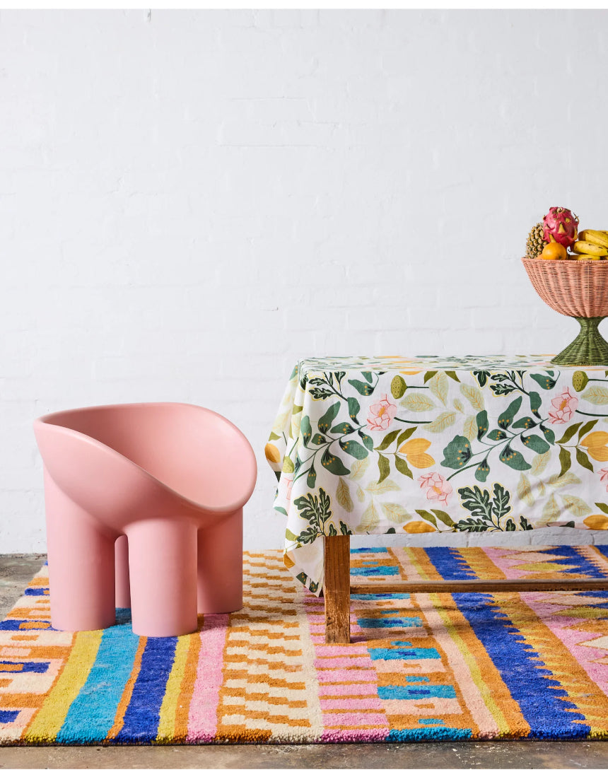Kip & Co Wander rectangular tablecloth with colorful, patterned fabric draped over a dining table for a vibrant look.