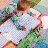 Kip & Co Dinosaur Roar organic baby romper with long sleeves and zip closure, featuring colorful dinosaur print on soft fabric.