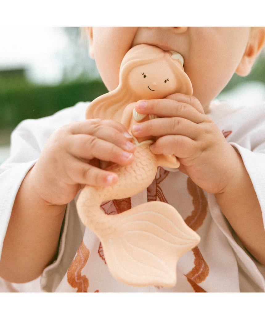 Winnie Parkes Maeve the Mermaid rubber teether in peach, soft and textured for soothing babies' gums.