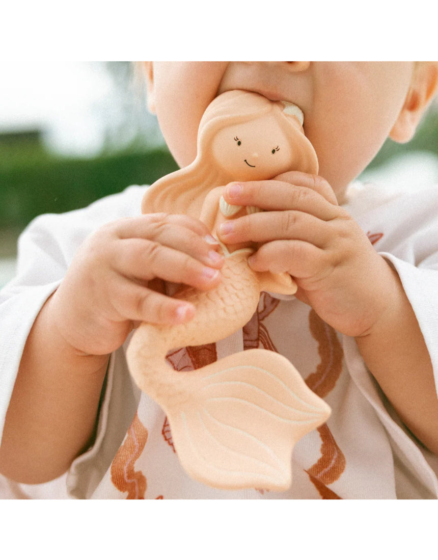 Winnie Parkes Maeve the Mermaid rubber teether in peach, soft and textured for soothing babies' gums.