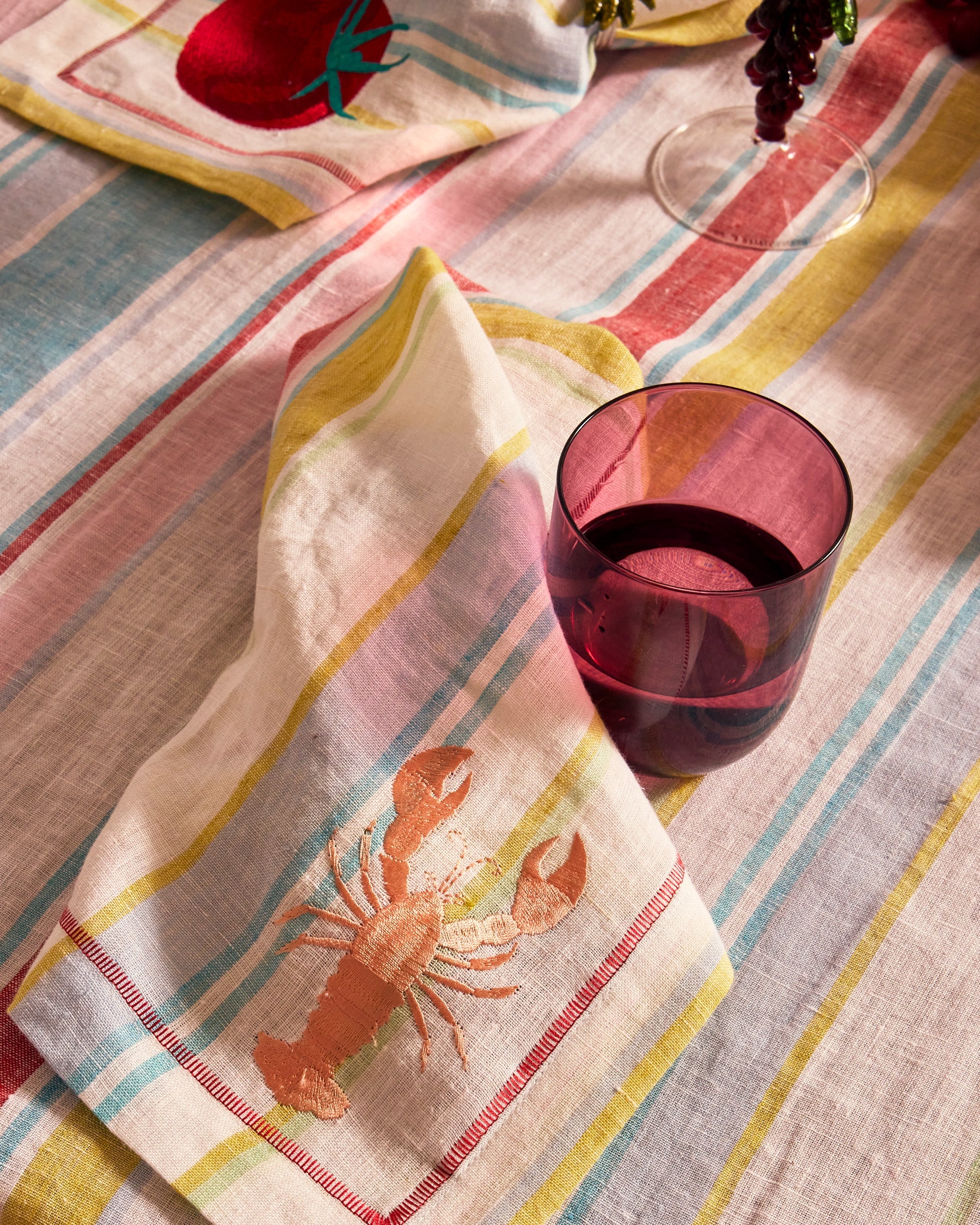 Kip & Co lilac fiesta carafe and matching glass set with colorful pattern, perfect for serving beverages in style.