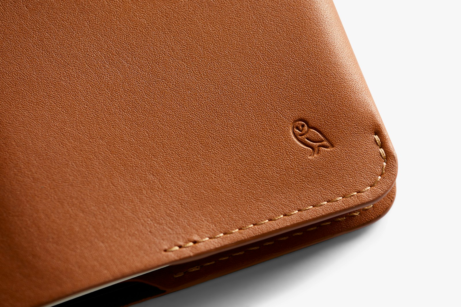 Bellroy caramel notebook cover showing smooth leather exterior and opening to reveal notebook inside.
