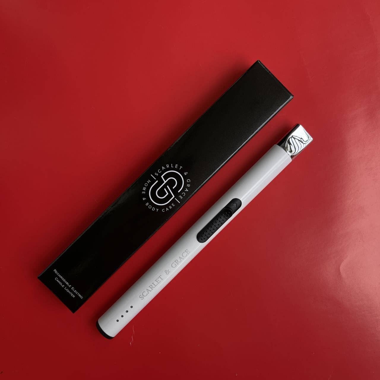 Scarlet & Grace Rechargeable Lighter in matte black with sleek design and safety button, compact and stylish for everyday use.