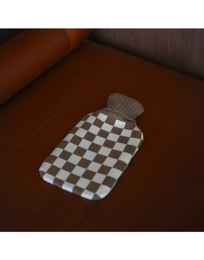Casa Rolio hot water bottle with mocha cover, showing soft fabric and rounded shape for warmth and comfort.